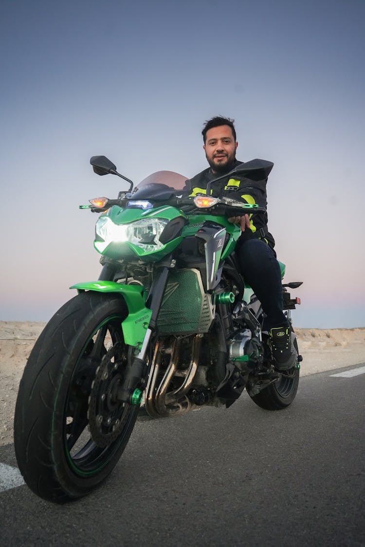 Man Riding On Green And Black Motorbike