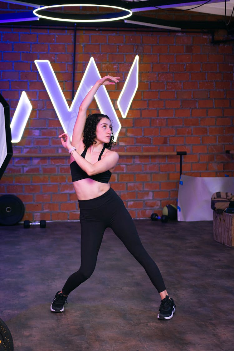 Woman Exercising At The Gym 