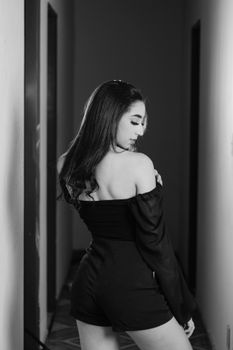 Stylish monochrome portrait of a woman looking over her shoulder in an elegant pose.