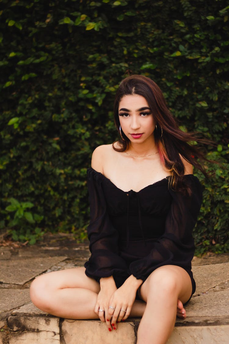 A Young Woman In A Black Off Shoulder Top