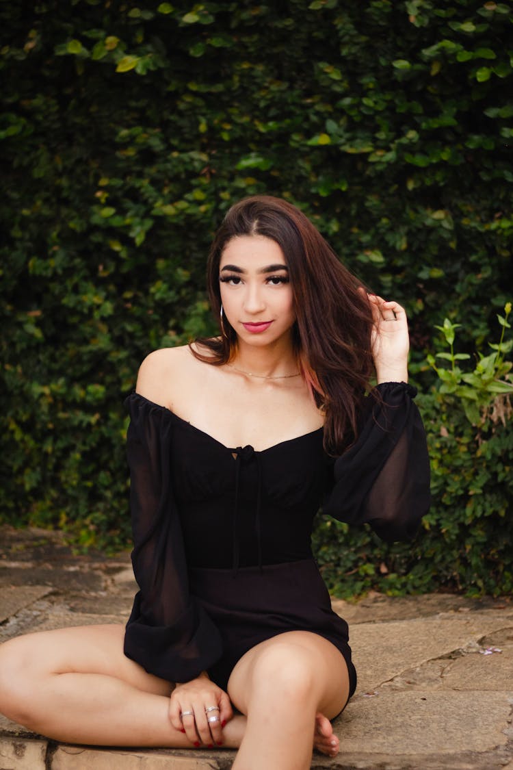 A Young Woman In A Black Off Shoulder Top