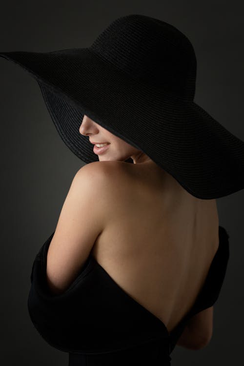 A Woman in Black Dress Wearing Black Hat
