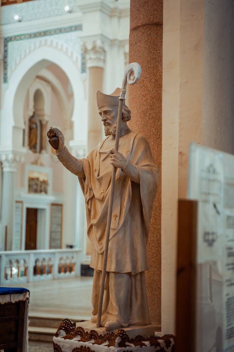 A Statue Of Saint Augustine In A Church