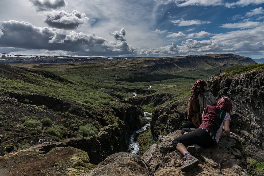 Landscape Photography of Woman Lying on Rock Mountain