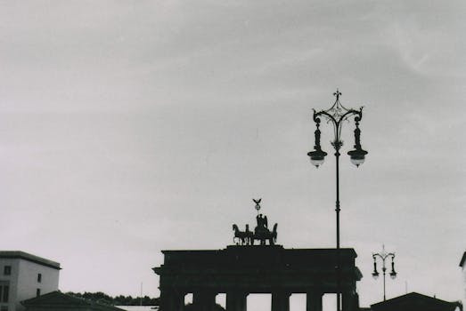 Dramatic black and white photo of Brandenburg Gate silhouette, Berlin