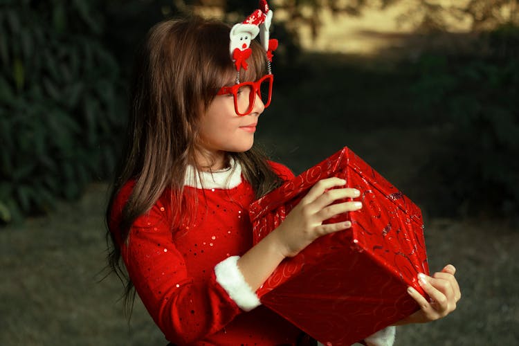 A Woman Holding A Red Box