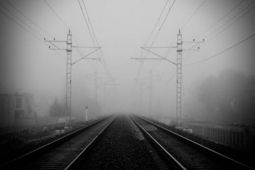 Grayscale Photo of Train Rails