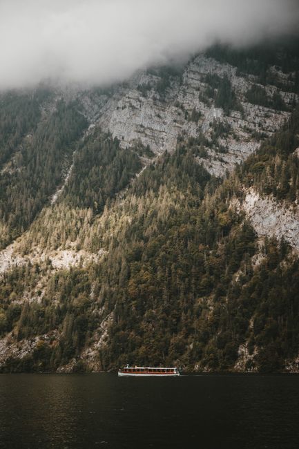 Idyllic landscape of Königssee Lake with misty mountains and tranquil waters in Bavaria, Germany.