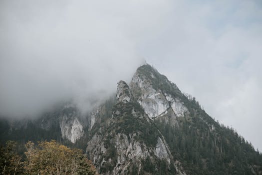 Foggy mountain landscape in Schönau am Königssee, Germany, featuring scenic peaks.