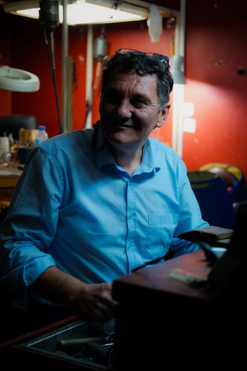 Free A skilled artisan in a workshop with illuminated tools, captured in Ankara. Stock Photo