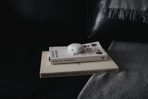 Бесплатное стоковое фото с earpods, диван, книги