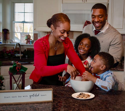 A Happy Family Having Fun Preparing Cookies in the Kitchen