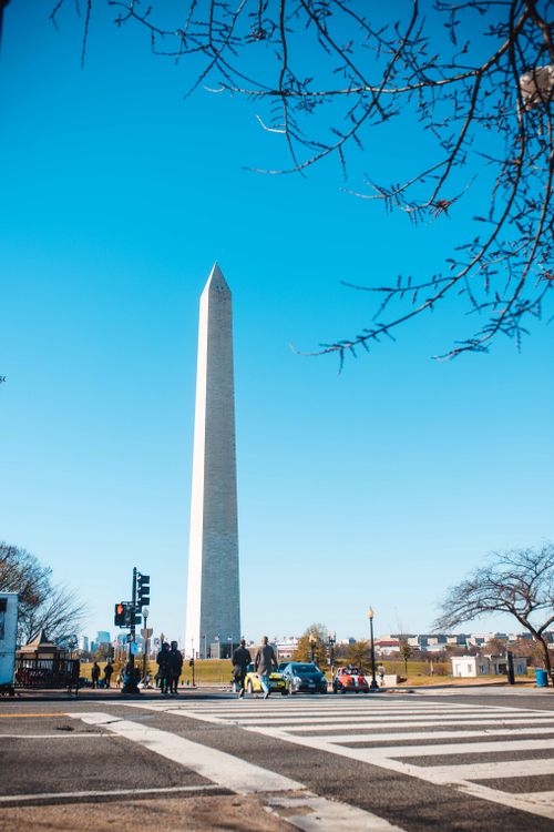 Free Scenic view of Washington Monument with blue sky and zebra crossing in winter, Washington, DC. Stock Photo