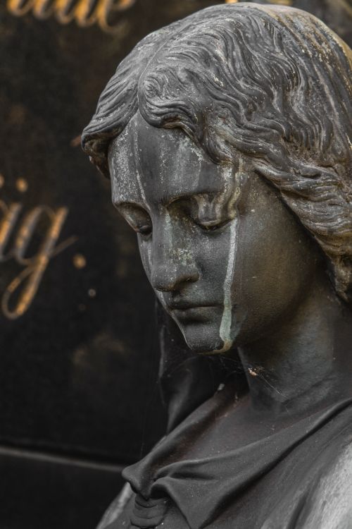 Free Close-up of an elegant bronze statue with a serene expression and artistic patina. Stock Photo