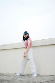 Fashionable woman wearing a crop top and white pants posing outdoors in Cimahi.