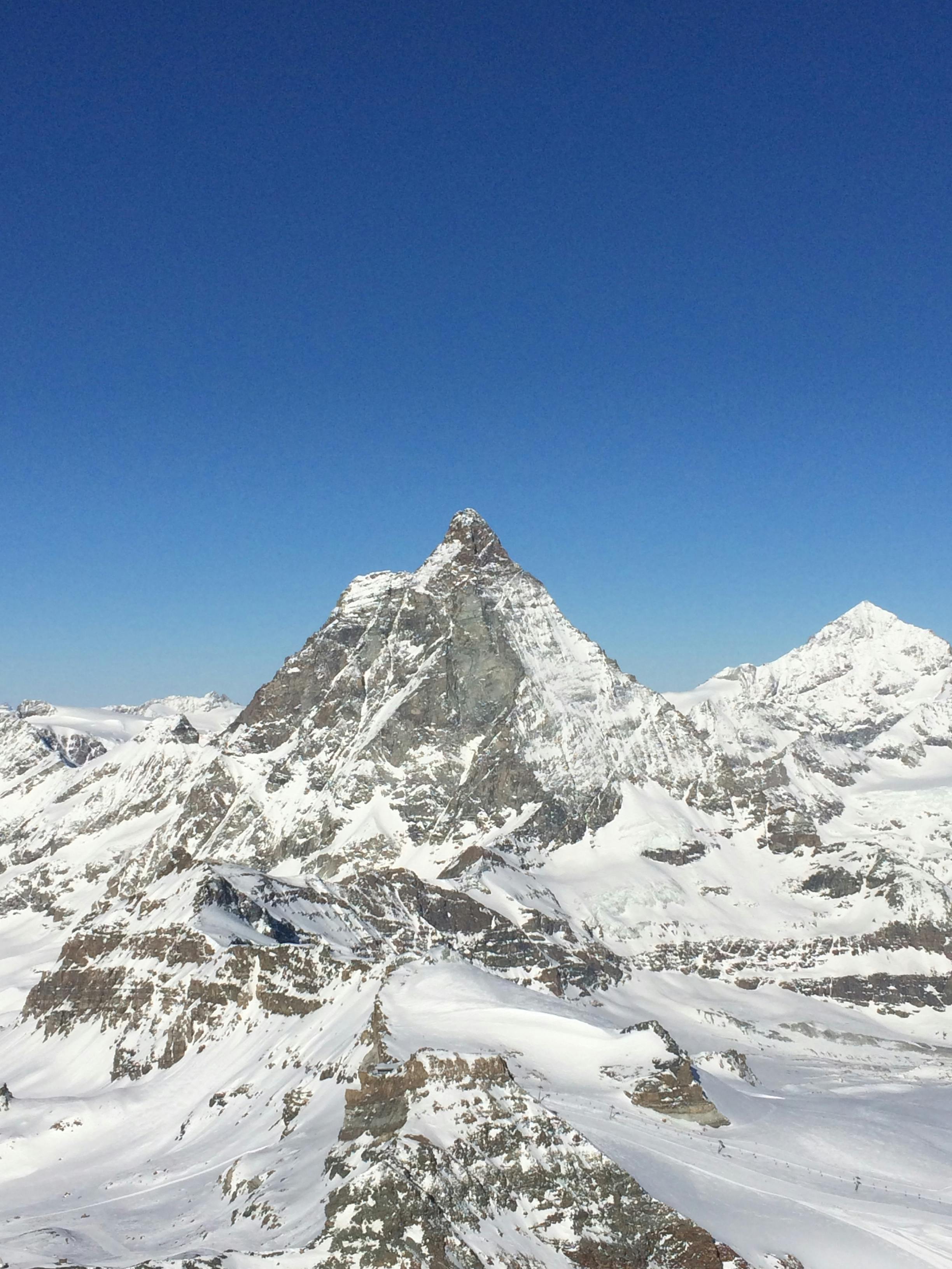 Prescription Goggle Inserts - A stunning aerial view of the snow-covered Matterhorn mountain in Zermatt, Switzerland, under a clear blue sky.