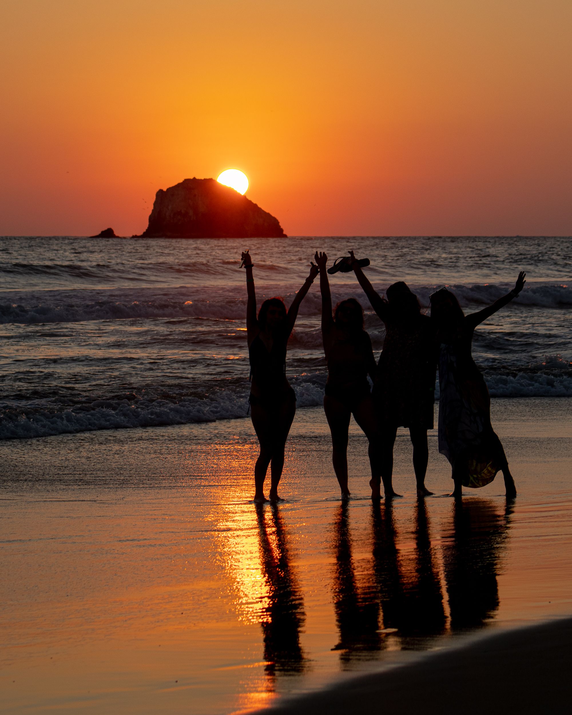 Silhouette of Women Standing Near Body of Water During Sunset · Free ...