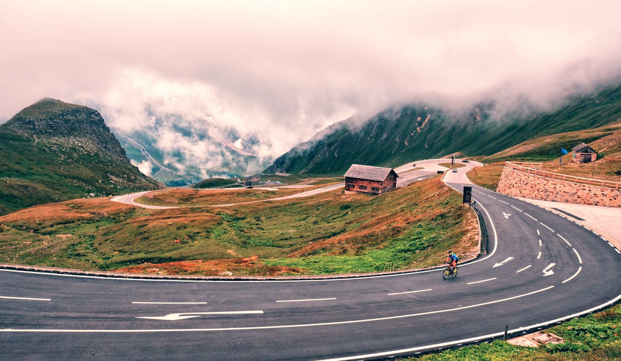 Man Riding Bike On Road 