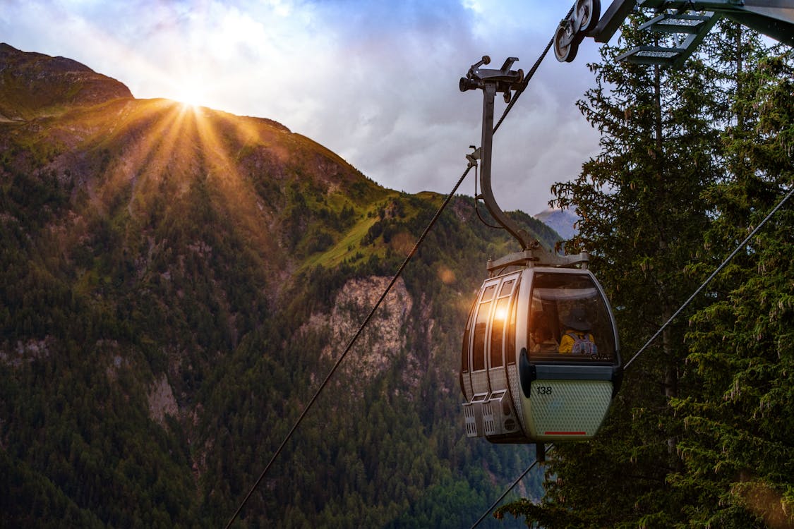 Free Selective Photo of Cable Car Surrounded by Tree and Hill Stock Photo