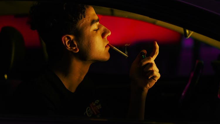 Man Smoking Inside A Car