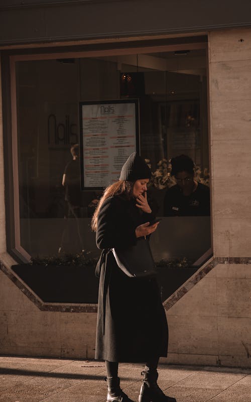 Woman in Coat Walking near Window