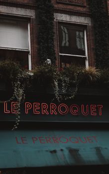 Exterior view of Le Perroquet with greenery on a Dublin building facade.