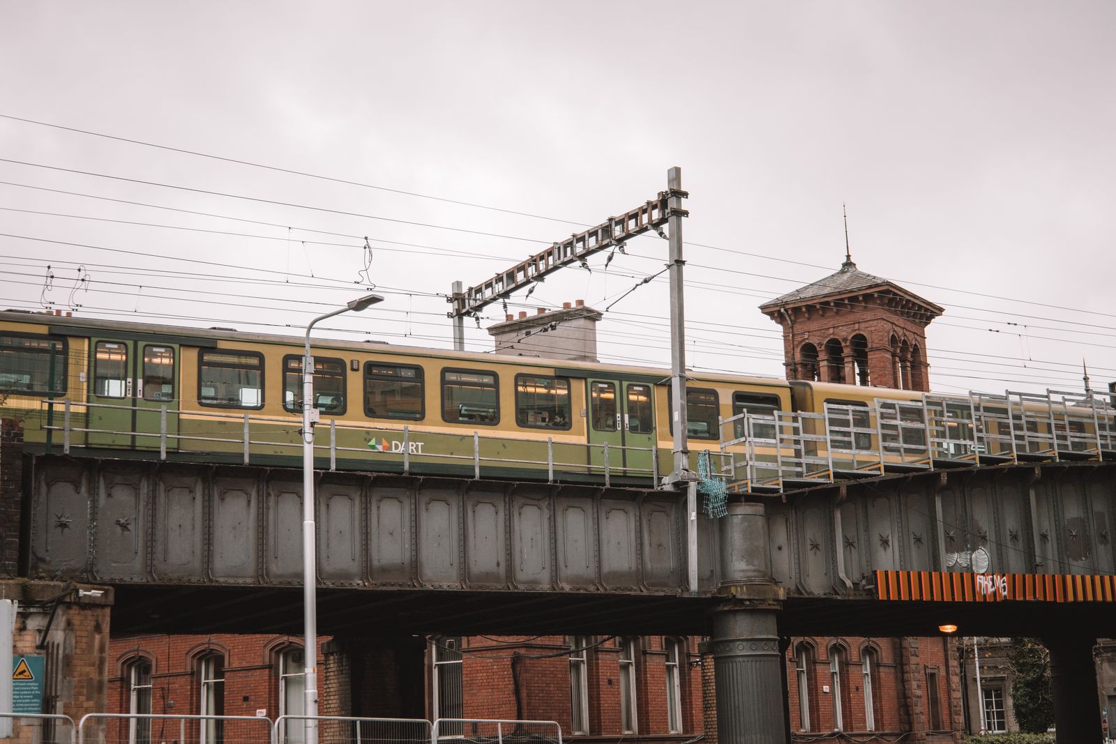 A DART train crossing a railway bridge in Dublin