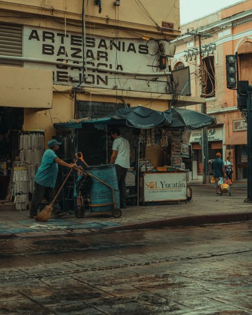 Free Urban street scene with people outside an artisan market in a bustling town. Stock Photo