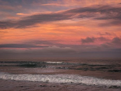 Tranquil ocean waves under a glowing sunset sky, perfect for calming visuals.