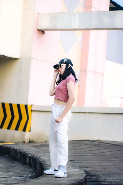 Woman in Pink Crop Shirt and White Pants