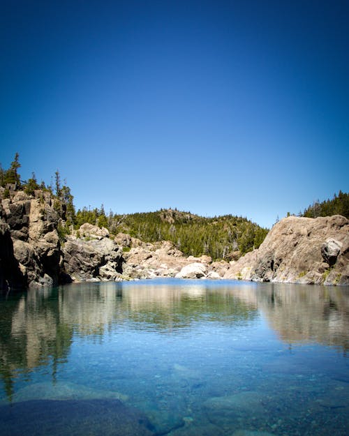 Small lagoon between stones and trees