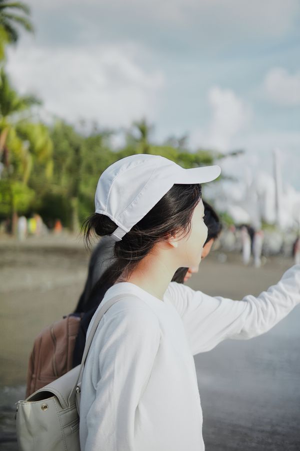 Person wearing white promotional cap
