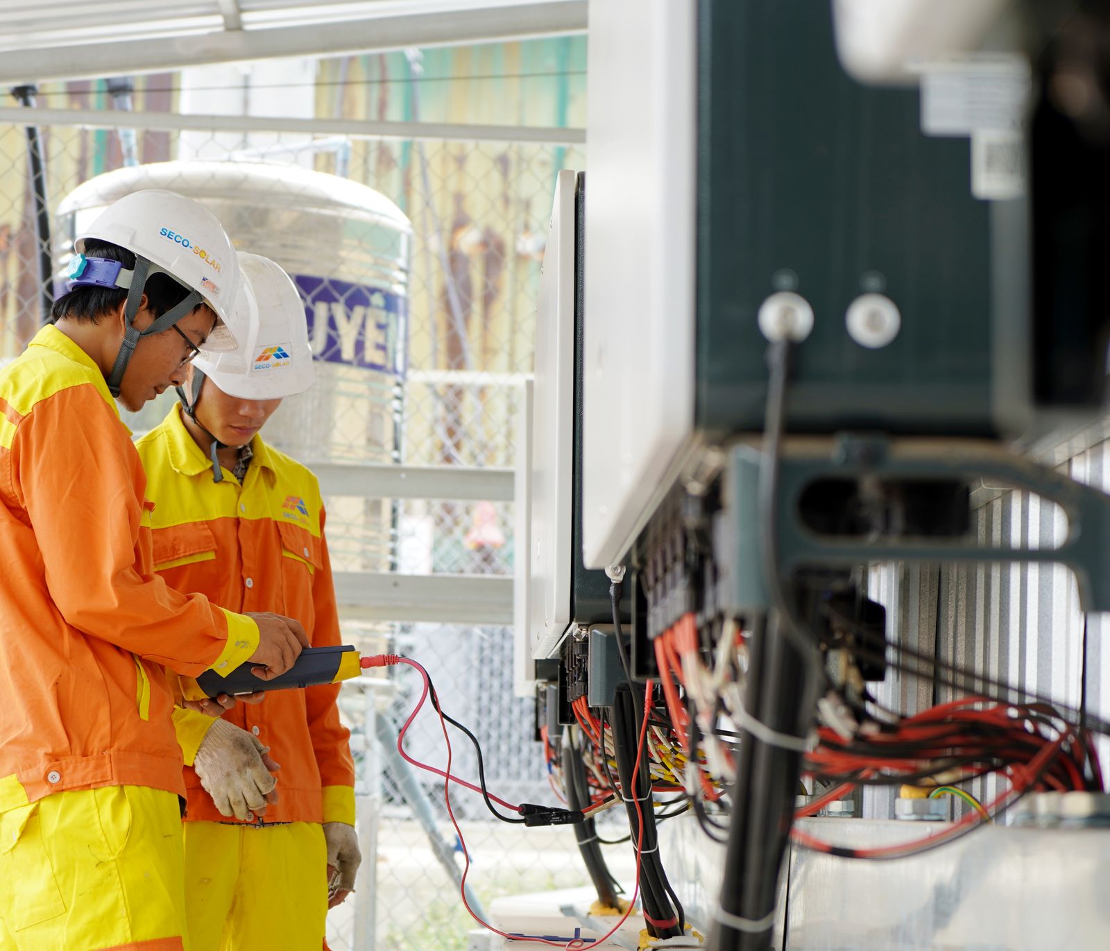Two qualified technicians carrying out electrical maintenance