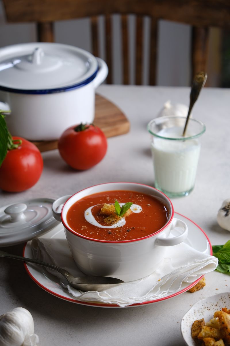 Tomato soup garnished with cream and herbs