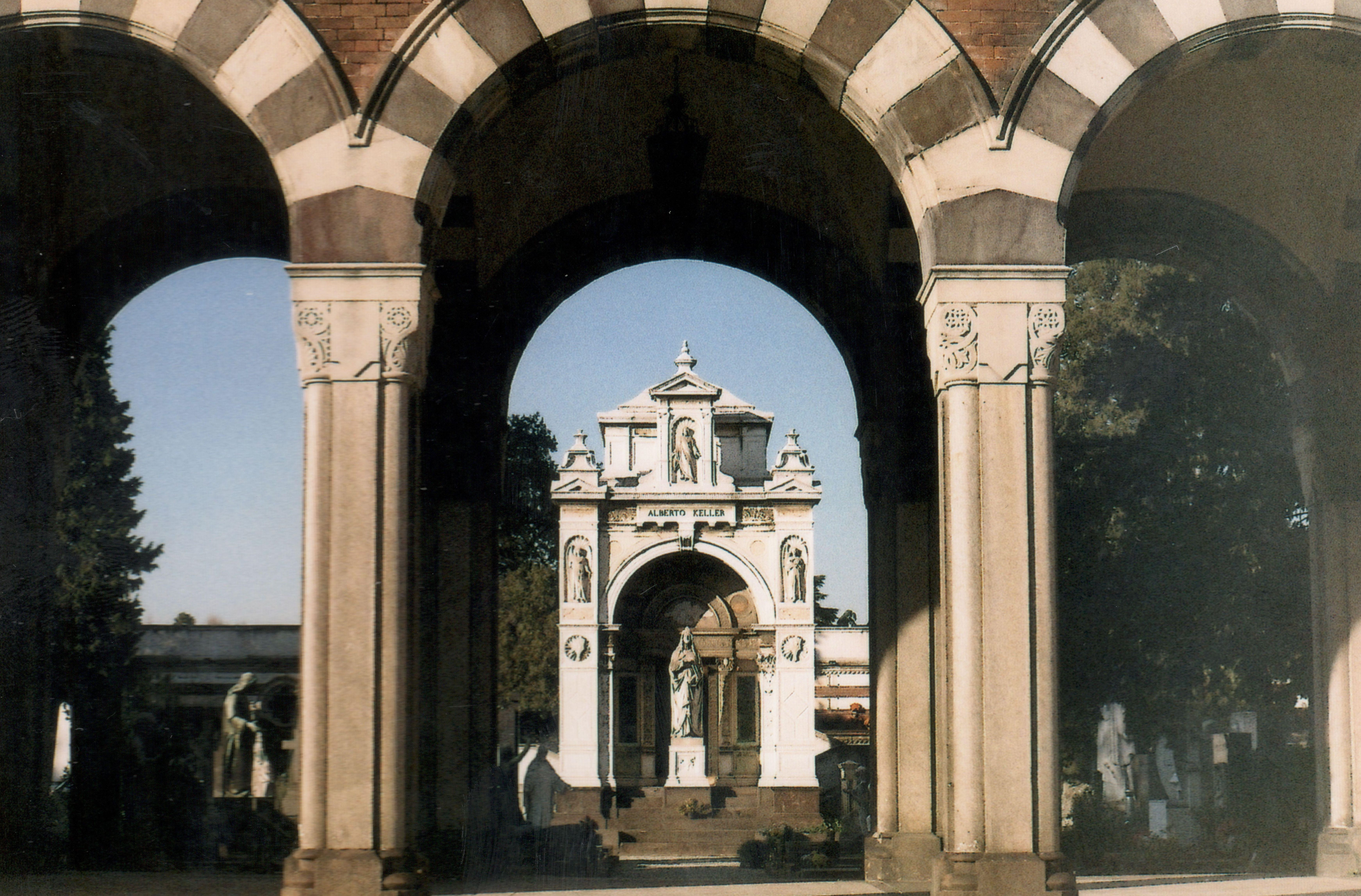 Classic monument framed by architectural arches in an outdoor setting, viewed in daylight.