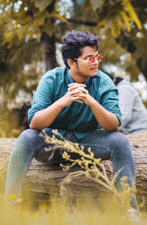 A Man Sitting On Branch