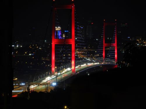 Free Stunning night view of the illuminated Bosphorus Bridge in Istanbul with city lights. Stock Photo
