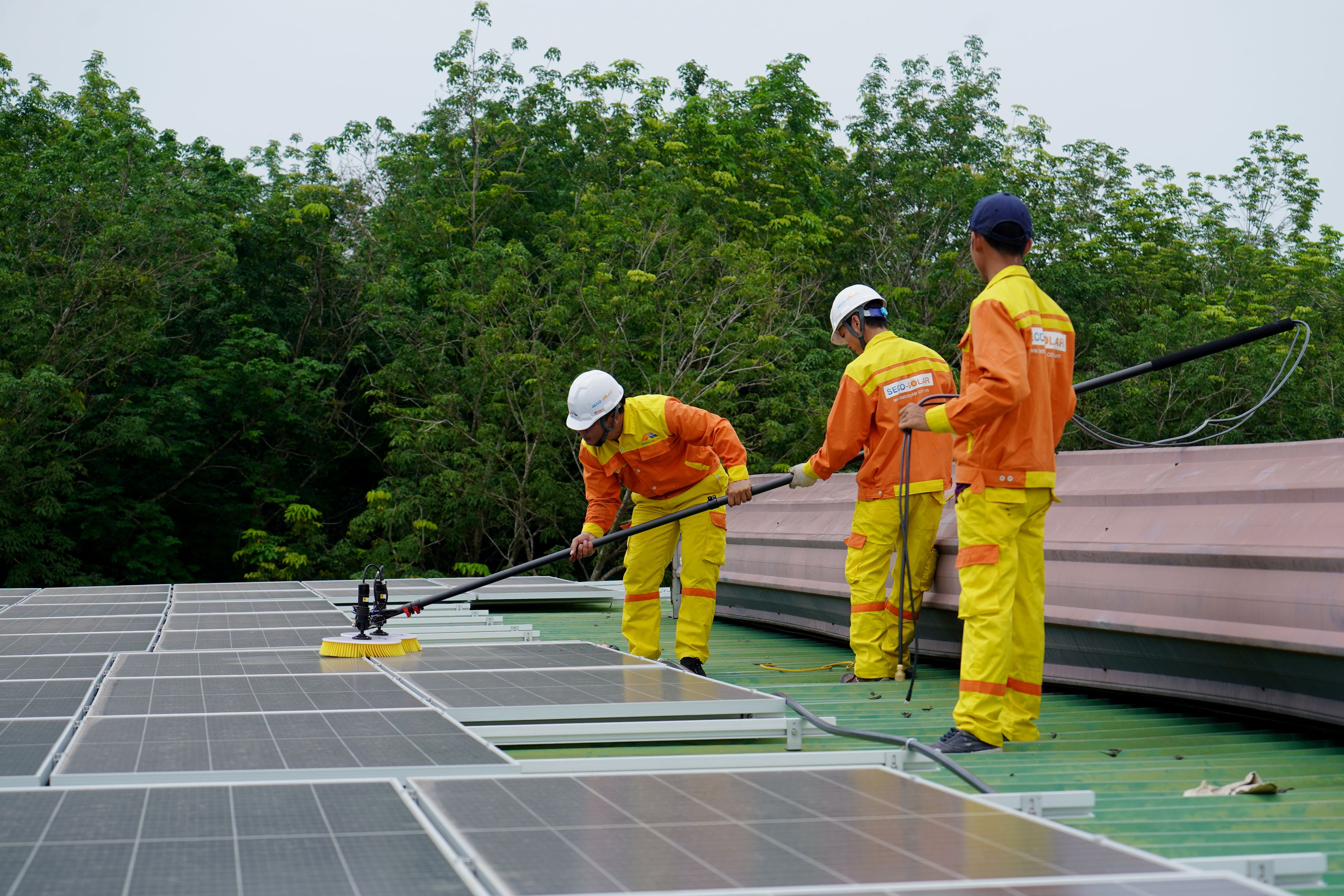Techniciens intervenant en toiture sur des équipements techniques d'un bâtiment