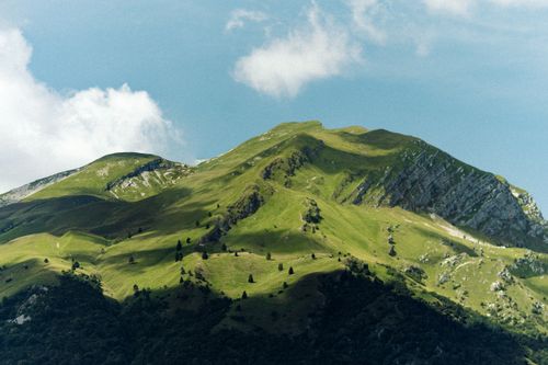 Free Breathtaking view of a lush green mountain under a clear blue sky. Stock Photo