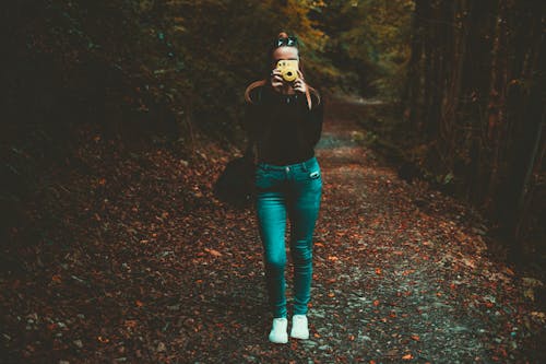 Woman Holding Yellow Camera 