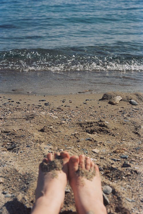 Free Feet at Sandy Beach Stock Photo