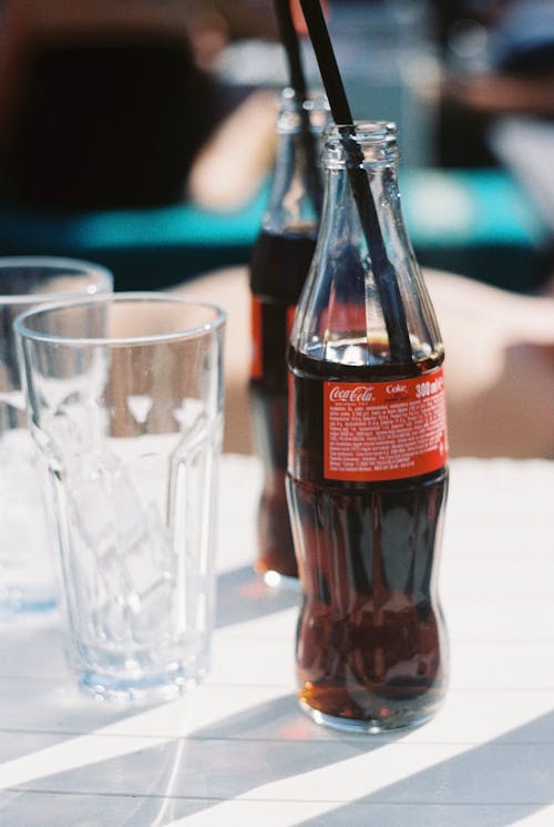 Soda Bottles and Clear Glass with Ice