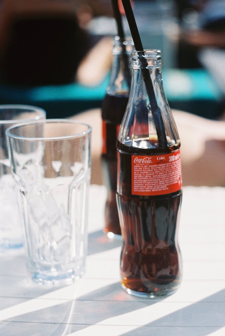 Soda Bottles And Clear Glass With Ice