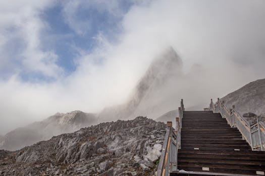 Dramatic mist surrounds the rugged staircase on Yulong Snow Mountain, Yunnan, China.