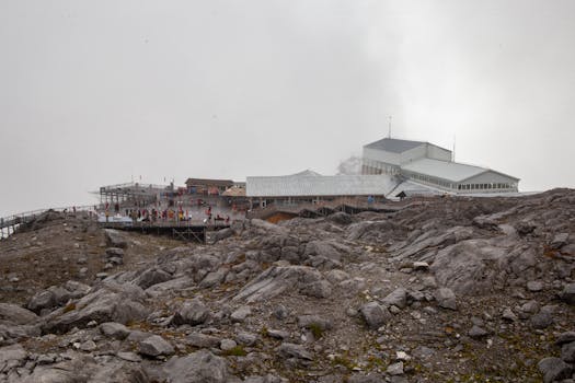 A rocky landscape with a facility on Jade Dragon Snow Mountain in China, showcasing a tourist attraction.