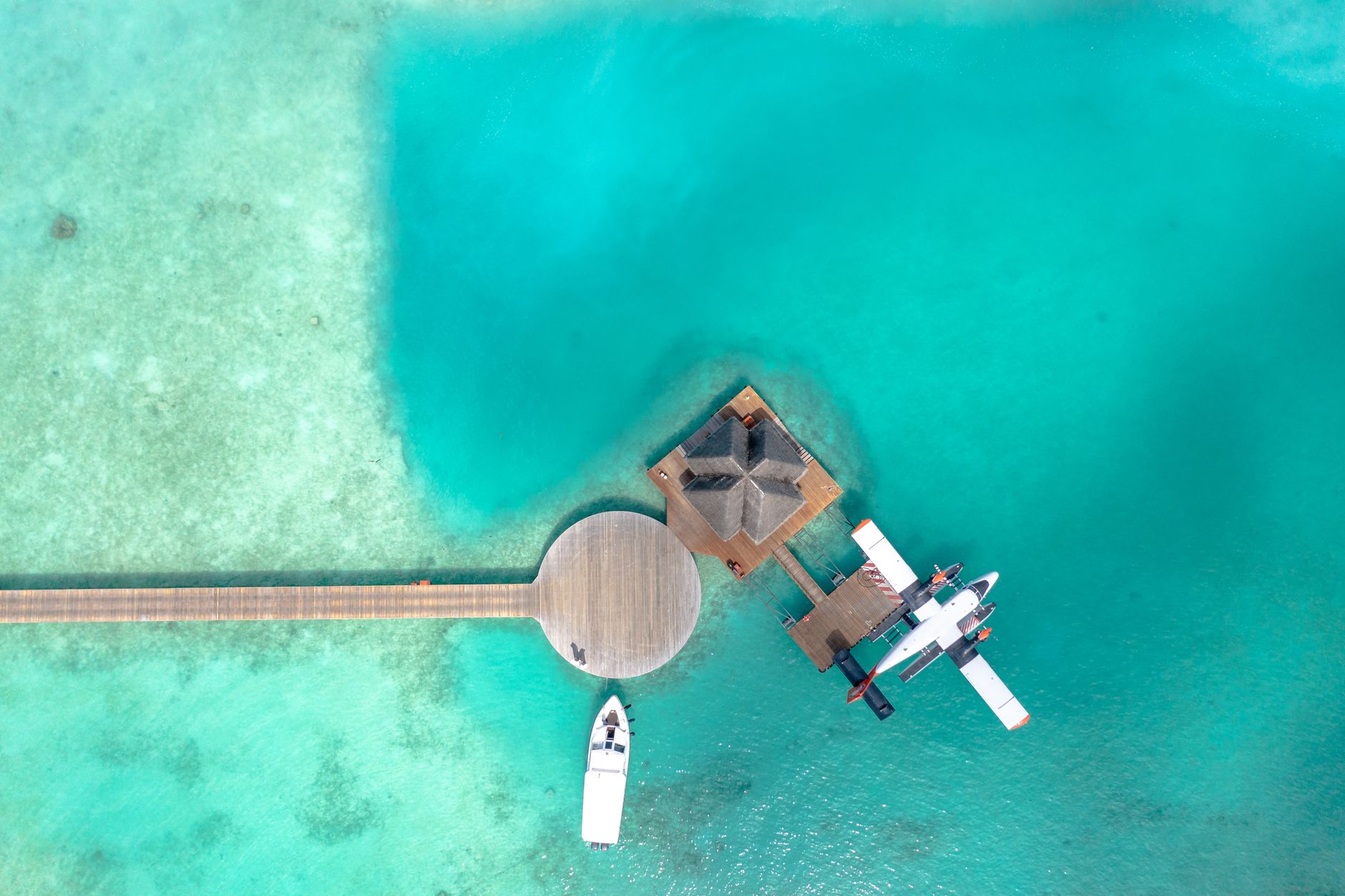 A seaplane waiting beside a Maldives jetty, the kind of extra leg travellers still factor into the dream.