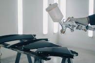 Close-up of Man Painting Car Details