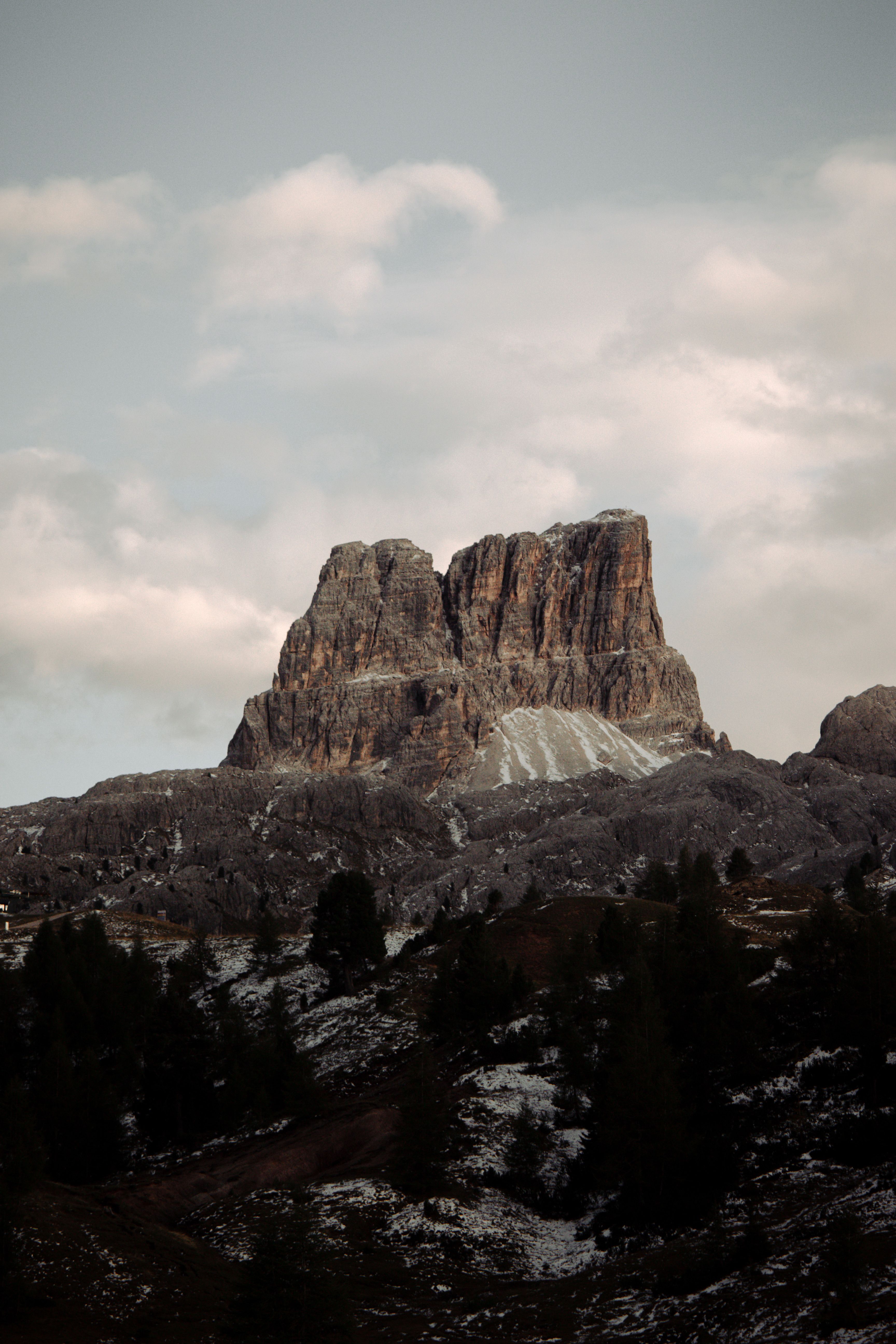 Captivating photograph of Averau Mountain in Veneto, showcasing its rocky majesty under a cloudy sky.
