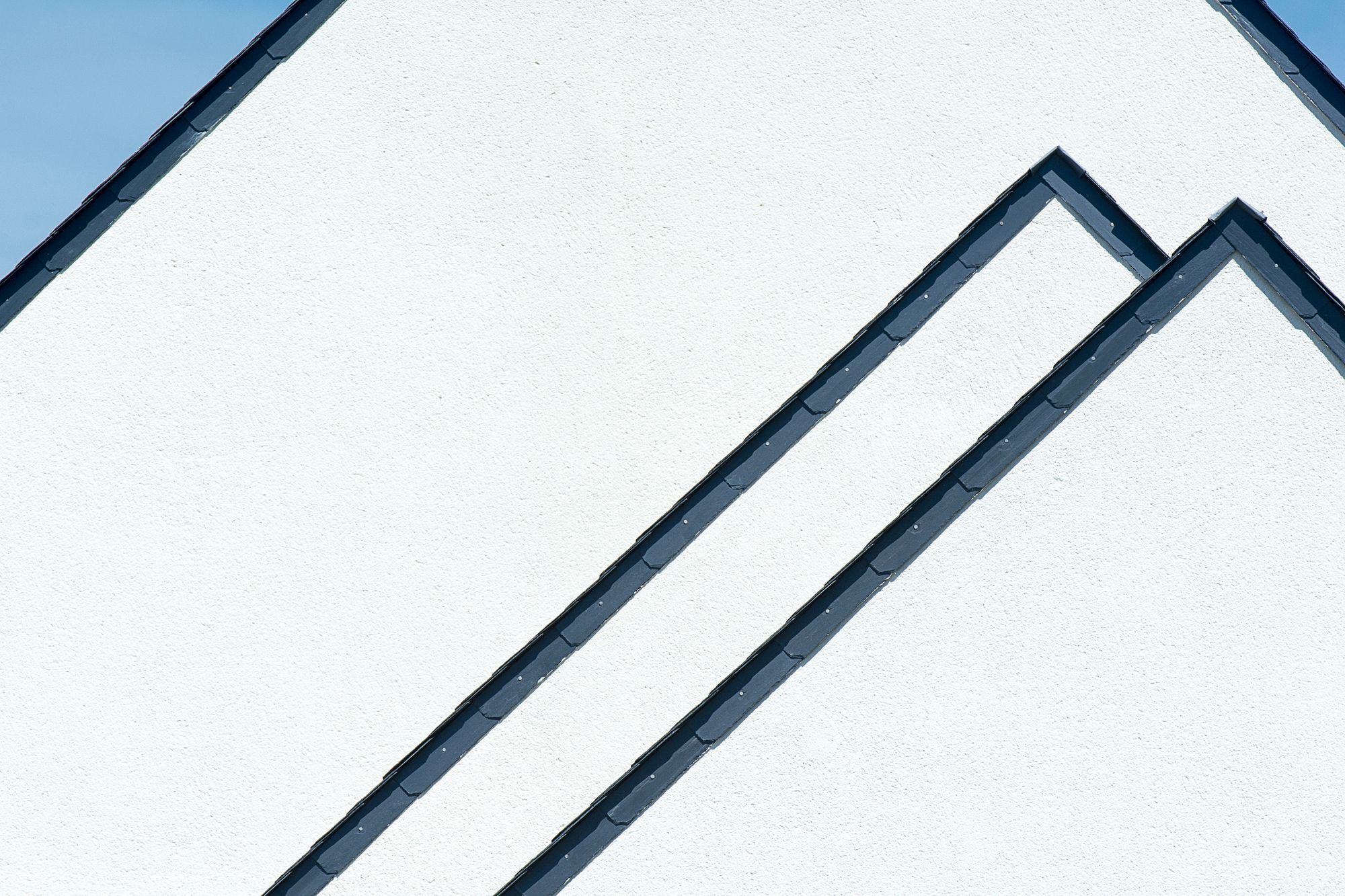 Architectural roofline against a clear blue sky