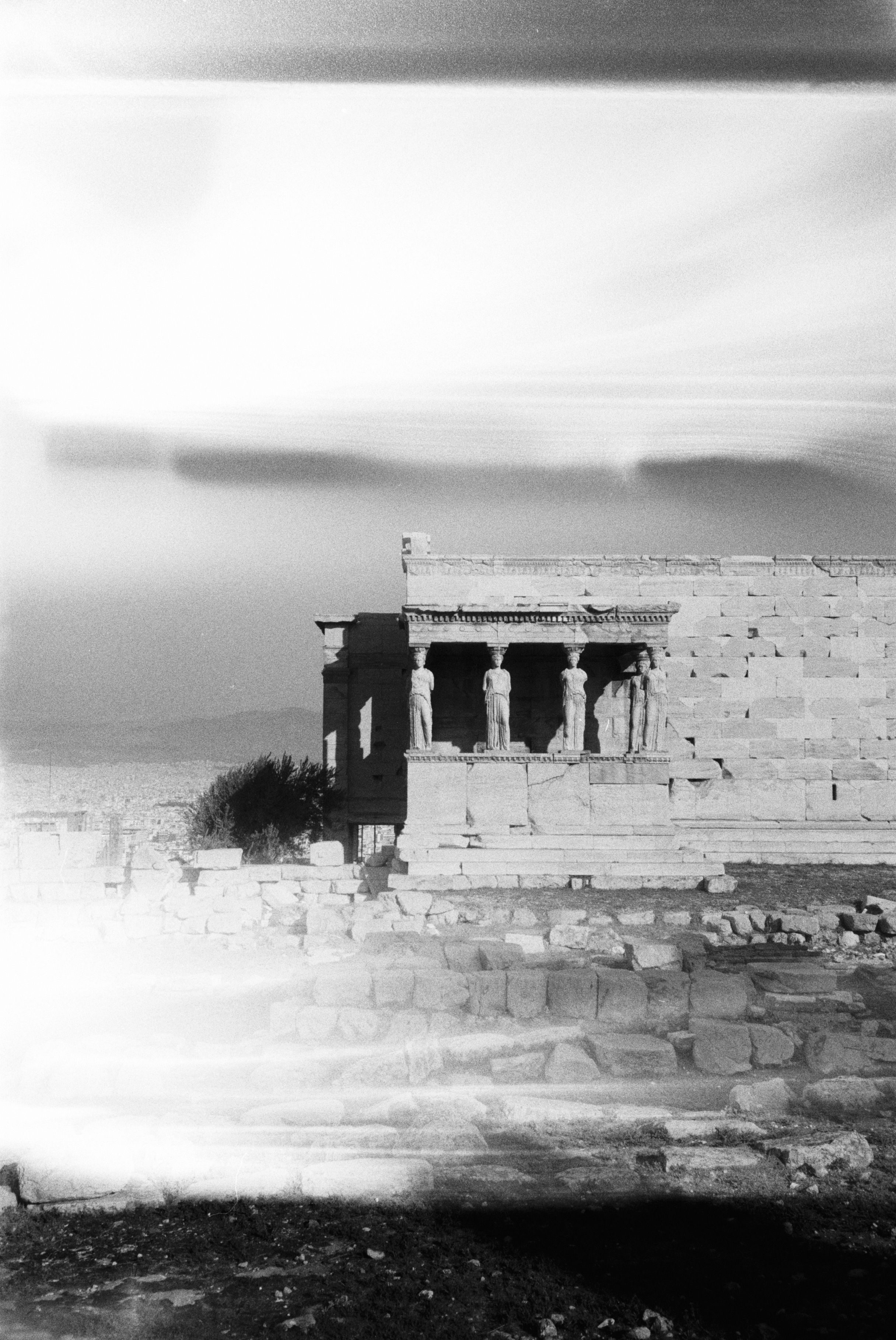 Black and white image of the Caryatids Porch at the Acropolis in Athens, Greece.